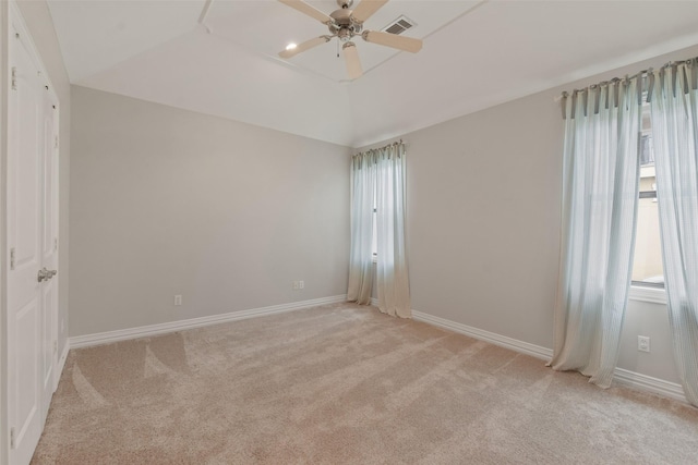 carpeted empty room with ceiling fan and vaulted ceiling