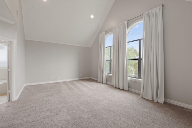 bonus room with a healthy amount of sunlight, lofted ceiling, and light carpet