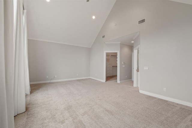 interior space with light colored carpet and high vaulted ceiling