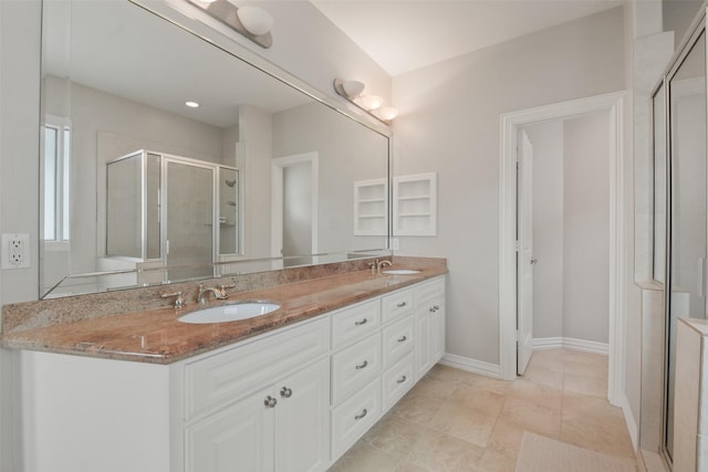 bathroom featuring tile patterned flooring, vanity, and an enclosed shower