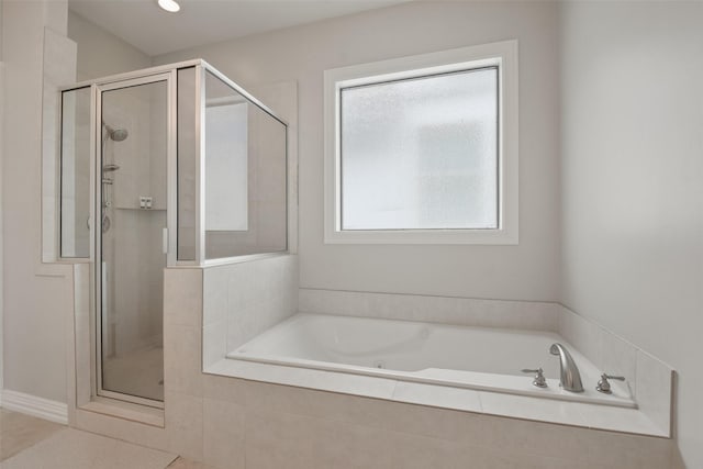 bathroom featuring tile patterned flooring and independent shower and bath