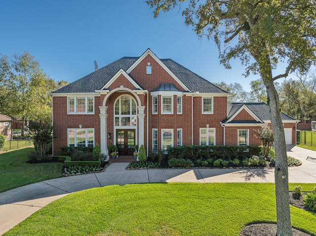 view of front of house with a front lawn and french doors