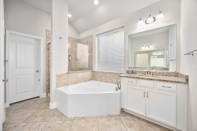 bathroom featuring tile patterned floors, vanity, separate shower and tub, and lofted ceiling