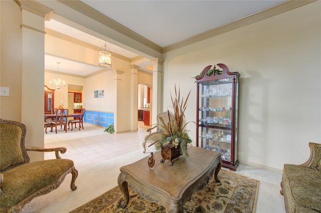 living area featuring decorative columns, an inviting chandelier, ornamental molding, and light colored carpet