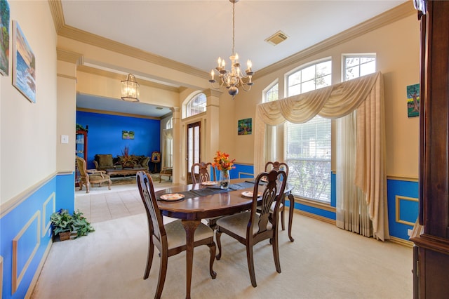 dining room with light carpet, an inviting chandelier, and crown molding