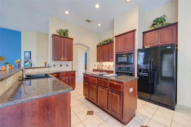 kitchen featuring black appliances, sink, light tile patterned floors, tasteful backsplash, and kitchen peninsula