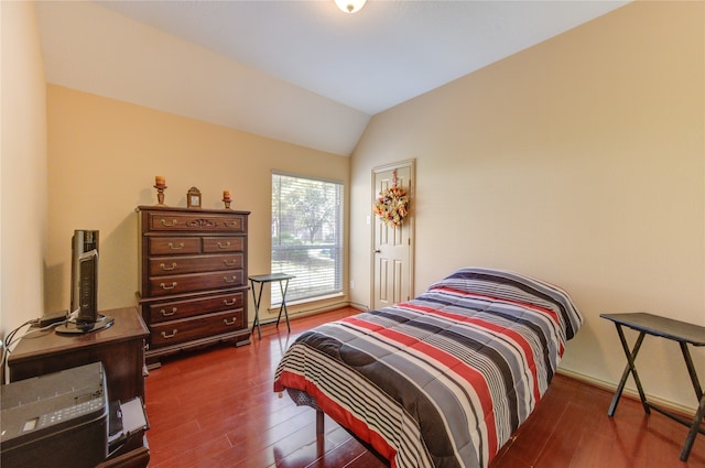 bedroom with dark wood-type flooring and vaulted ceiling