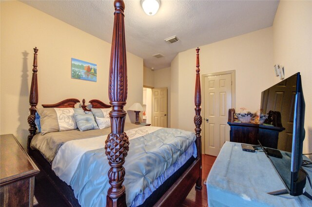 bedroom with visible vents and wood finished floors