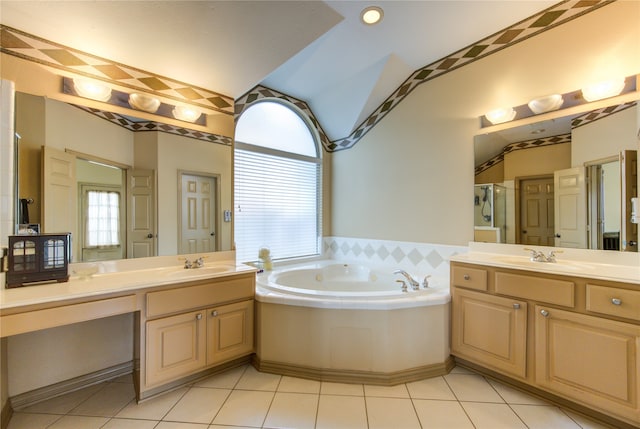 bathroom featuring tile patterned flooring, shower with separate bathtub, and vanity