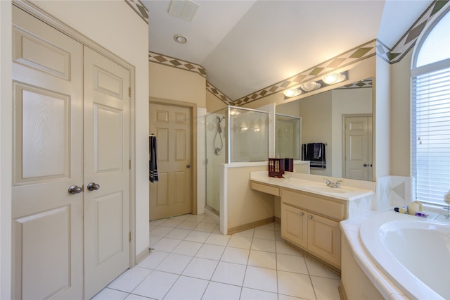 bathroom with tile patterned floors, vanity, lofted ceiling, and independent shower and bath