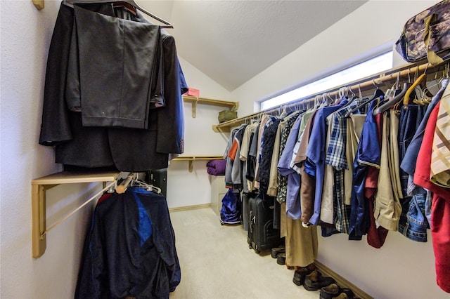 walk in closet featuring vaulted ceiling and carpet floors