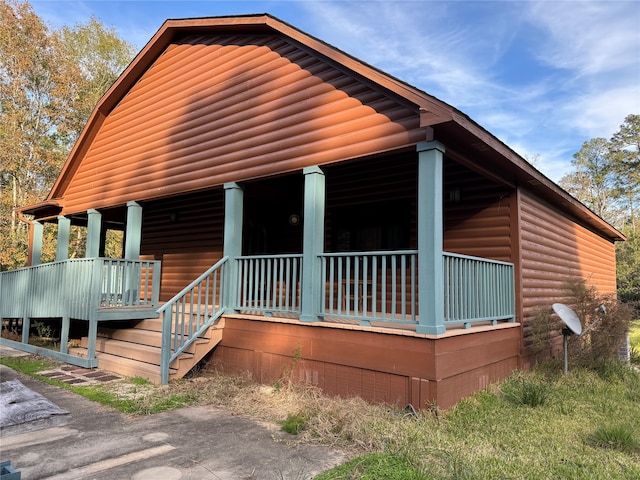 log-style house featuring a porch