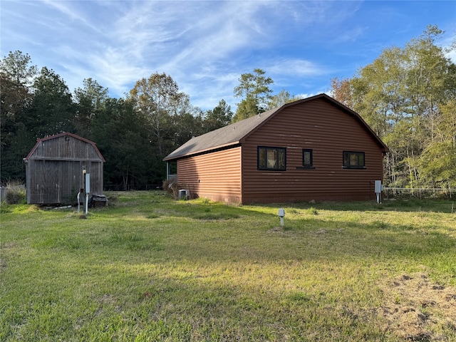 view of home's exterior with a yard and a storage shed