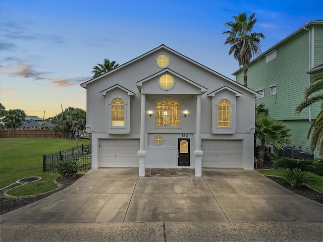 view of front of home featuring a lawn and a garage