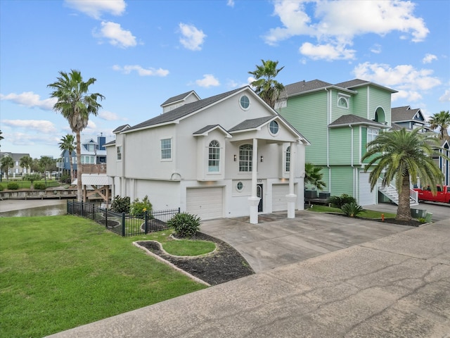 view of front of property featuring a front lawn and a garage