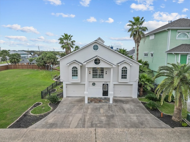 view of front property featuring a garage and a front lawn