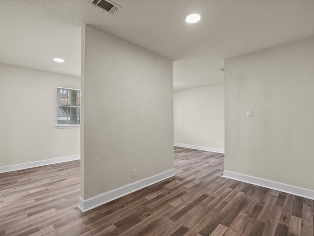 unfurnished room featuring dark hardwood / wood-style floors