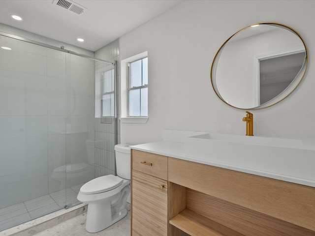 bathroom featuring tile patterned flooring, vanity, toilet, and a shower with shower door