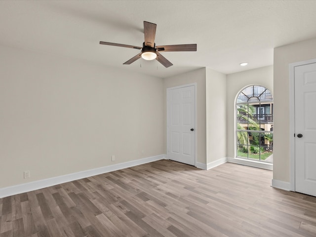 spare room with ceiling fan and light hardwood / wood-style floors