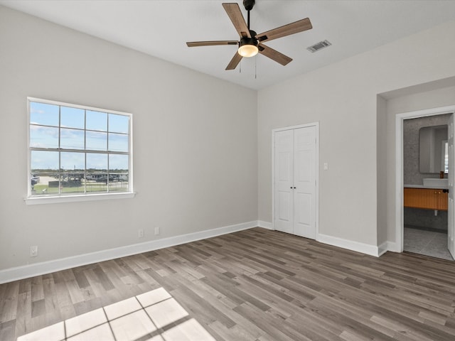 spare room featuring hardwood / wood-style flooring and ceiling fan