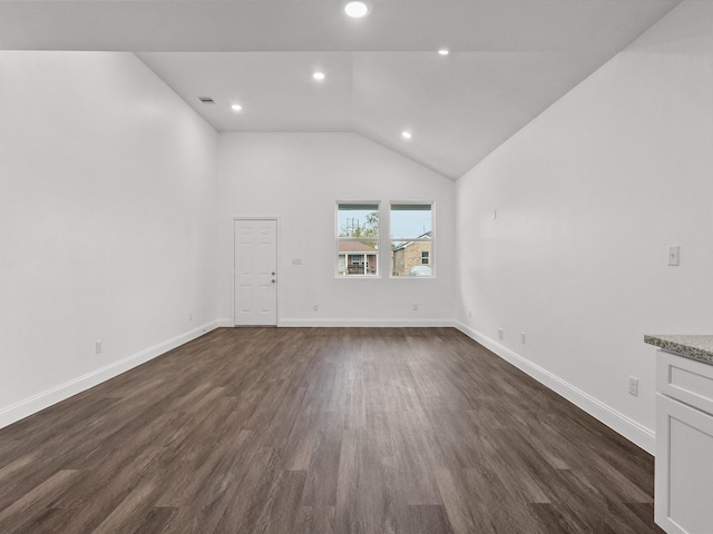 unfurnished living room featuring dark hardwood / wood-style flooring and lofted ceiling