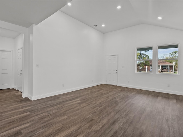 unfurnished room featuring dark hardwood / wood-style floors and vaulted ceiling