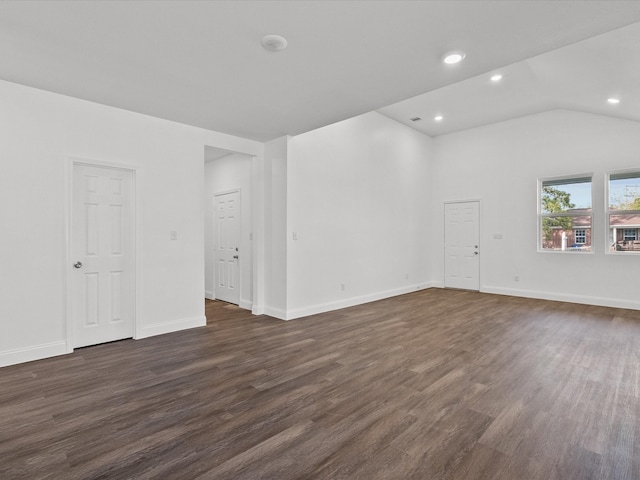 empty room with vaulted ceiling and dark wood-type flooring