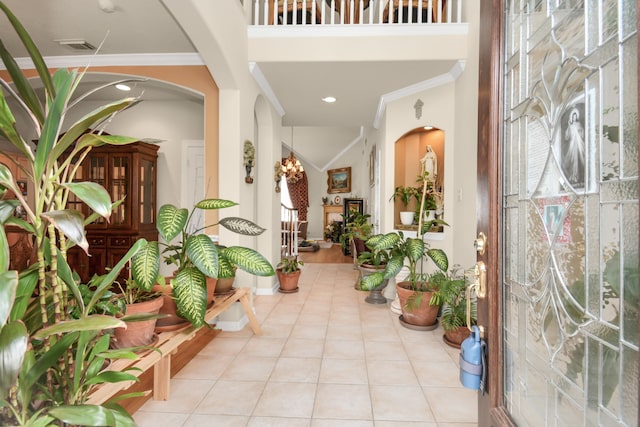 interior space featuring light tile patterned floors and crown molding