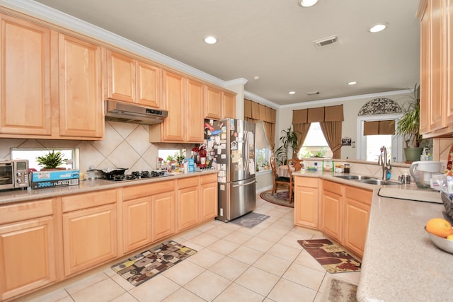 kitchen featuring light brown cabinets, stainless steel appliances, and sink