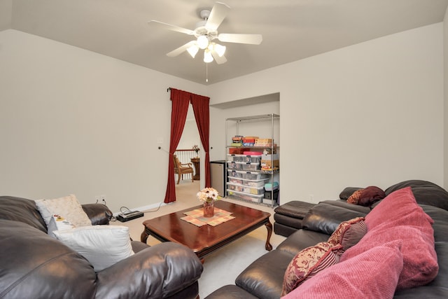 carpeted living room with ceiling fan