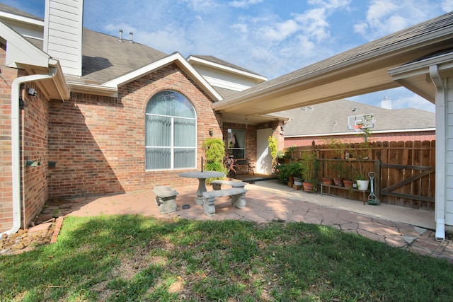 exterior space featuring a patio area and a lawn