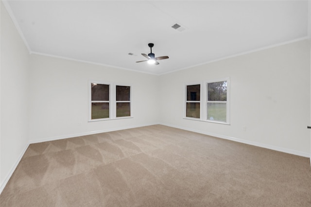 empty room with ceiling fan, light colored carpet, and crown molding