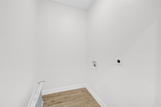 clothes washing area with electric dryer hookup, light hardwood / wood-style floors, and hookup for a washing machine