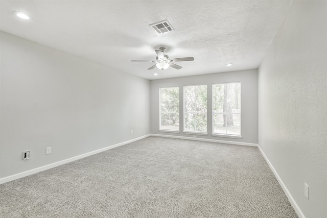 unfurnished room featuring ceiling fan and carpet