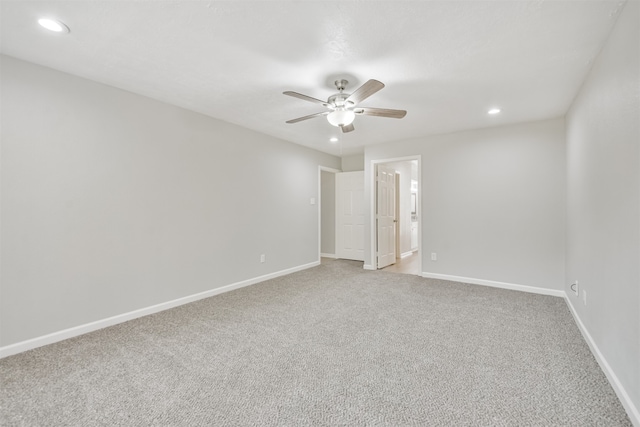 spare room featuring ceiling fan and light carpet