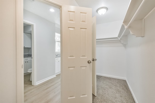 spacious closet featuring light hardwood / wood-style floors