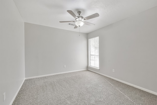 carpeted spare room with ceiling fan