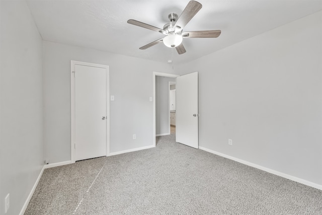 empty room with ceiling fan and carpet floors