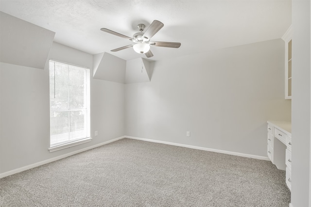 bonus room featuring carpet, ceiling fan, and a wealth of natural light