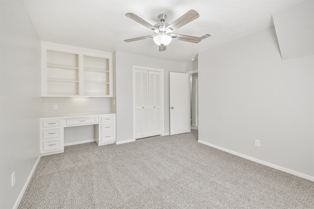 unfurnished bedroom featuring light carpet and ceiling fan