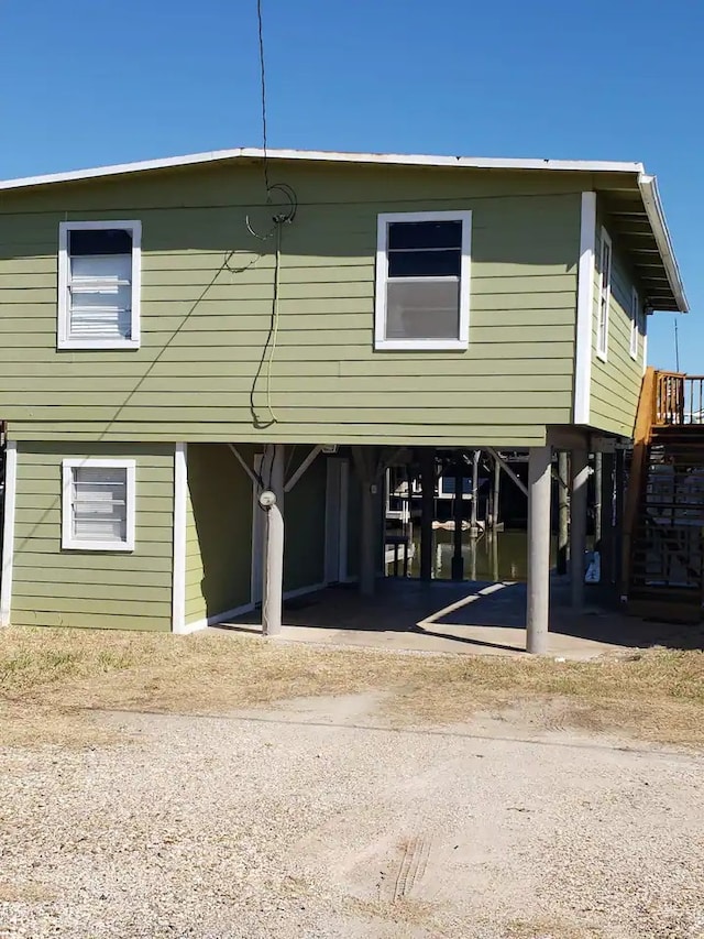 back of property featuring a carport