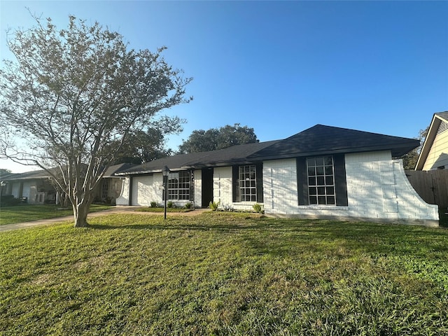 ranch-style home featuring a front yard and a garage