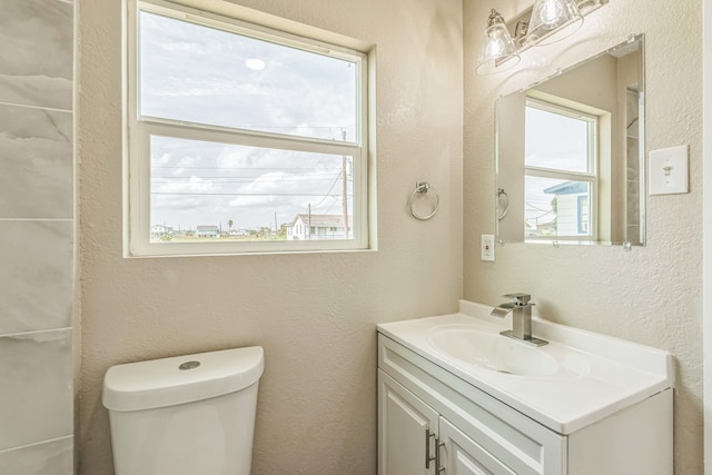 bathroom featuring vanity and toilet