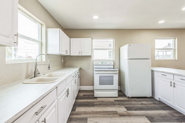 kitchen with dark hardwood / wood-style floors, white cabinetry, white appliances, and sink