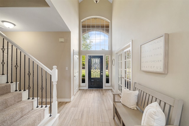 entrance foyer featuring light hardwood / wood-style floors and a high ceiling