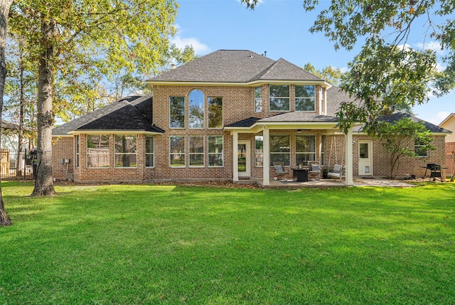 back of property with a patio and a lawn