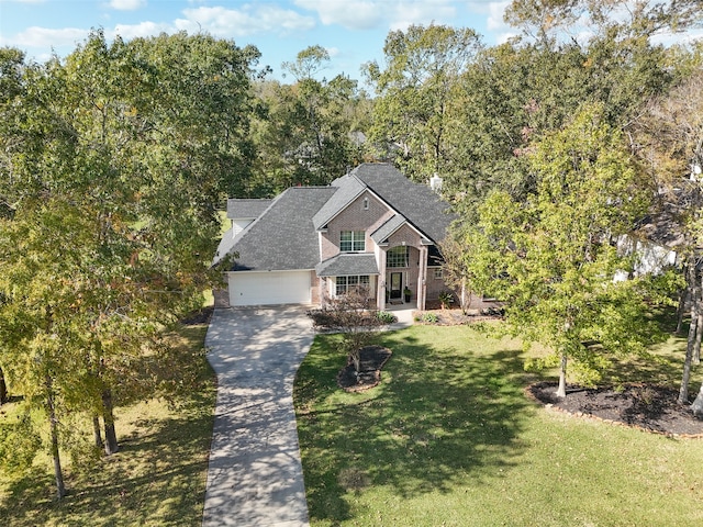 view of front facade with a front yard, a porch, and a garage