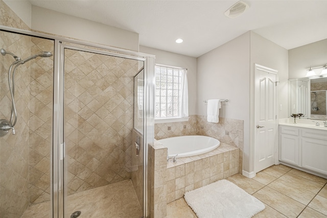 bathroom with tile patterned floors, vanity, and separate shower and tub