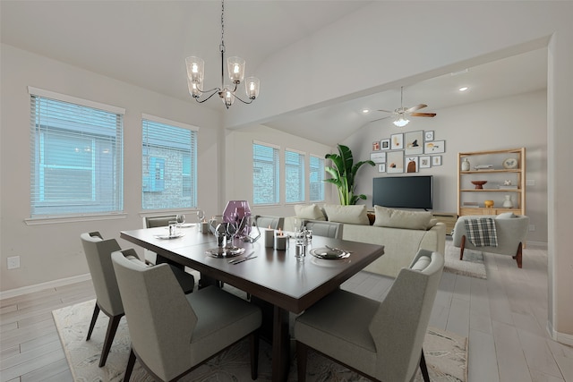 dining room with light hardwood / wood-style flooring, ceiling fan with notable chandelier, and lofted ceiling