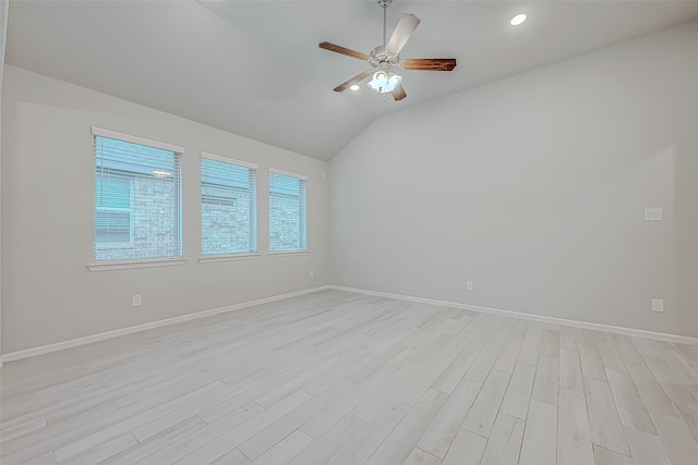 unfurnished room with ceiling fan, light hardwood / wood-style floors, and vaulted ceiling